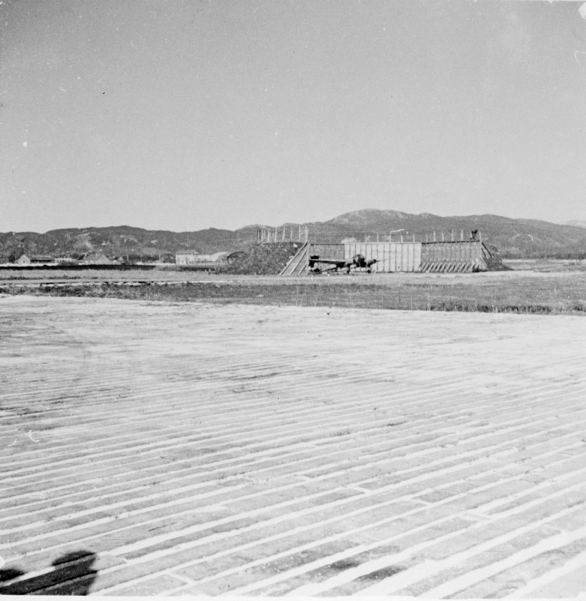 Bodø flyplass 13. mai 1945. I bildets bakre del ses en parkert Messerschmitt 104.