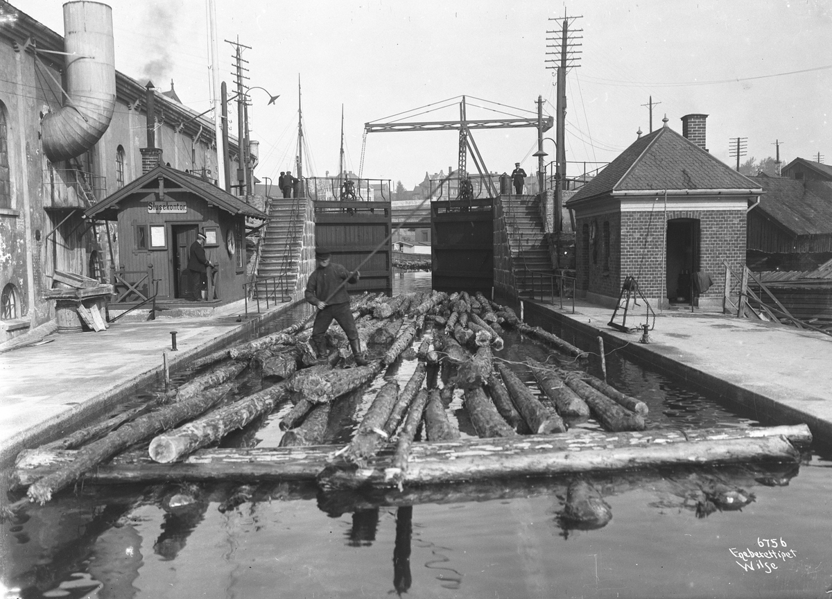 Tømmerfløting gjennom sluser i Skienvassdraget. Fotografert i 1907.