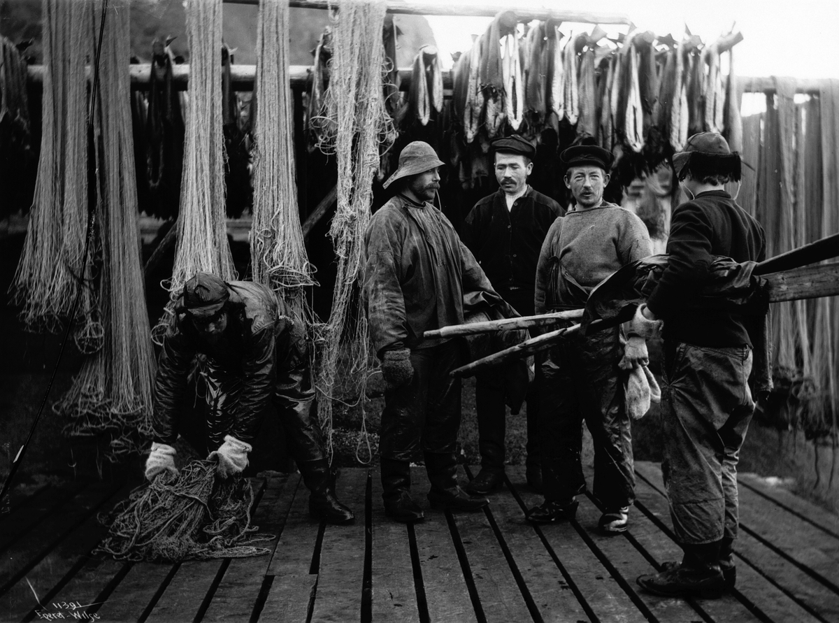 En gruppe fiskere og fiskegarn, antatt fra Svolvær, Vågan, Lofoten, Nordland 10.03.1910.