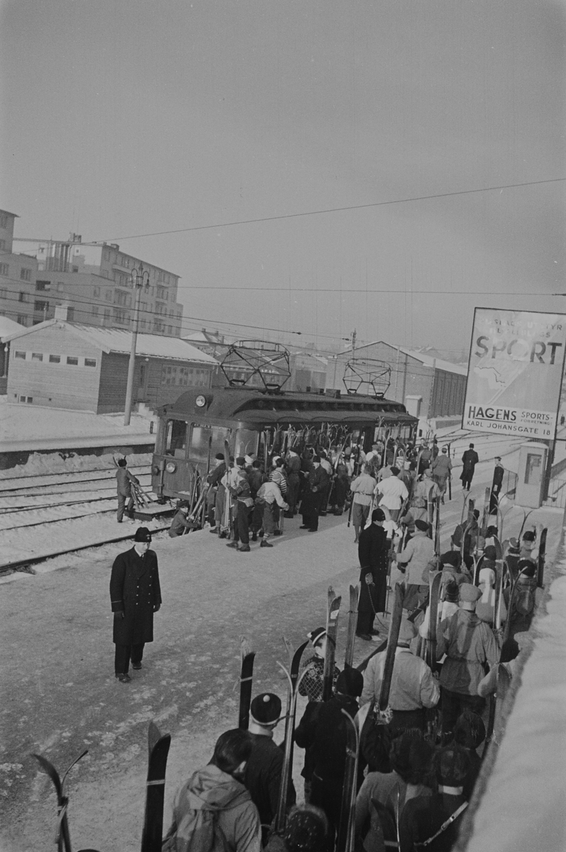 Kø med skikledde mennersker på Holmenkollbanen ved Majorstuen Stasjon. Fotografert 1940.