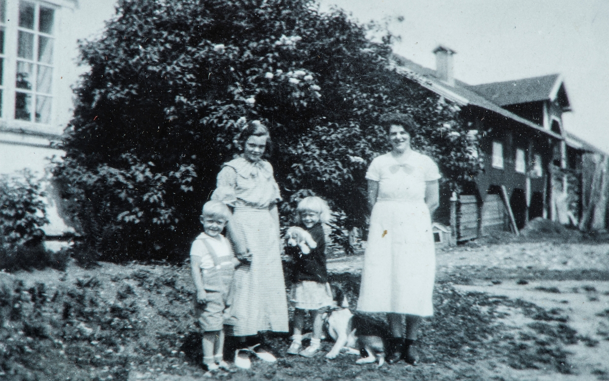 Øvre Tomter (60/1). Fra tunet på garden med hovedbygningen og låven.  Barna er Helga og Helge Andreas Prestrud. Pauline Husom til høgre.