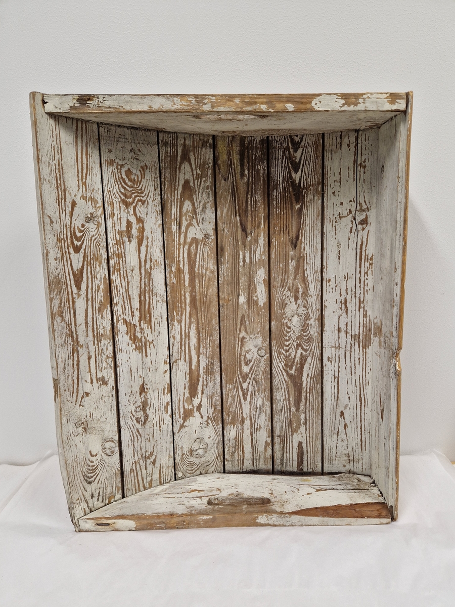 En trekasse med kuv bunn og åpninger på sidene til handtak