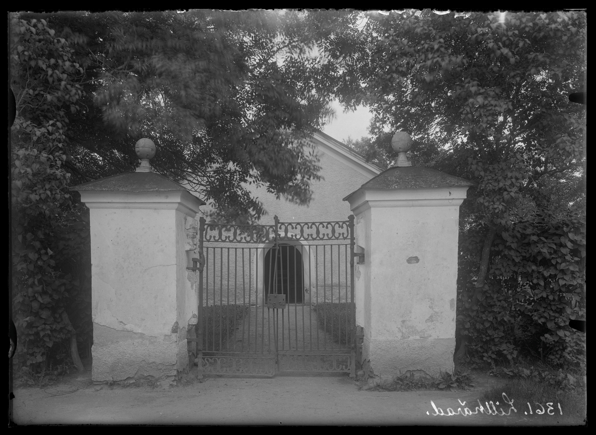 Lillhärads kyrka med västra kyrkoporten och västra grinden.