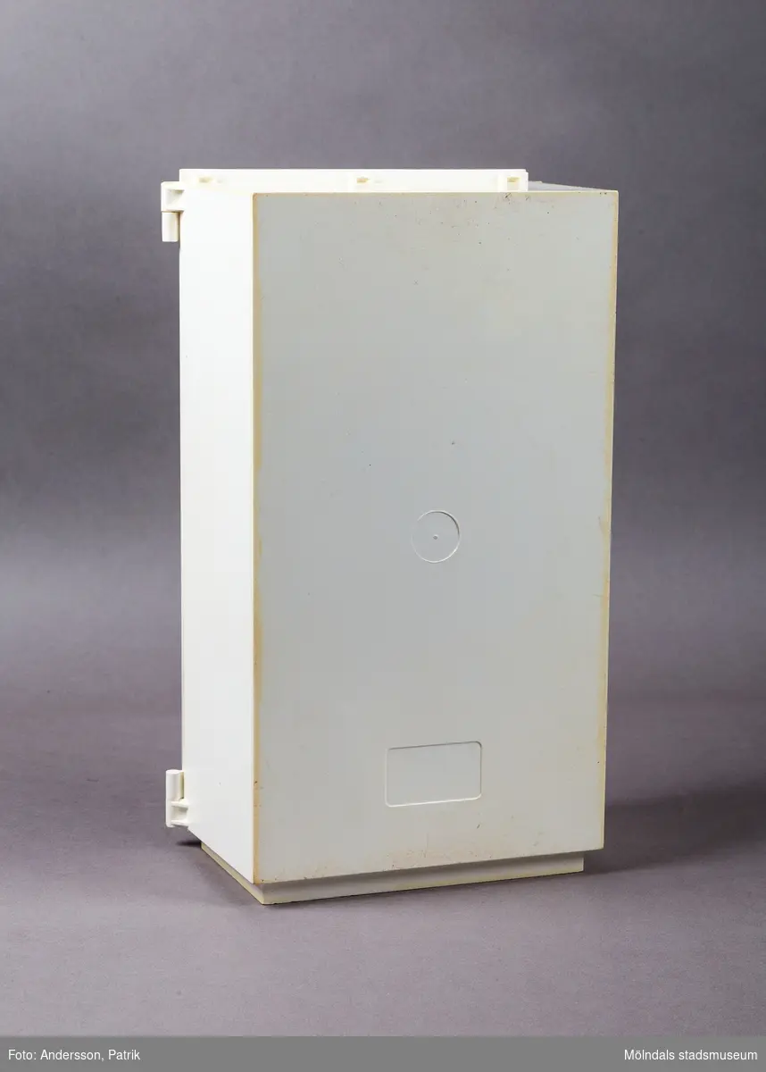 Vit leksaksgarderob med gulddekor. Till skåpet hör fem galgar och två papiljotter. 

Inuti garderoben finns en liten byrå med tre lådor (en låda saknas dock).  På insidan av den vänstra garderobsdörren finns en spegel och en skohylla. På den högra dörren finns en liten hylla och en stång för skärp och scarfs. 

Garderoben är ett tillbehör till dockan Sindy.

Sindy var en docka som tillverkades av ett stort antal företag på licens från Pedigree Dolls & Toys: Pedigree under åren 1963-1986, Hasbro 1987-1996, Funskool 1994-2006 samt Vivid Imaginations 1998-2003.