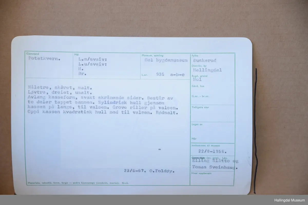 Avlang kasseform, svakt skrånende sider. Består av to deler tappet sammen. Sylindrisk hull gjennom kassen på langs, til valsen. Grove riller på valsen. Oppå kassen kvadratisk hull ned til valsen. Rødmalt.
23/6-67 O. Foldøy.