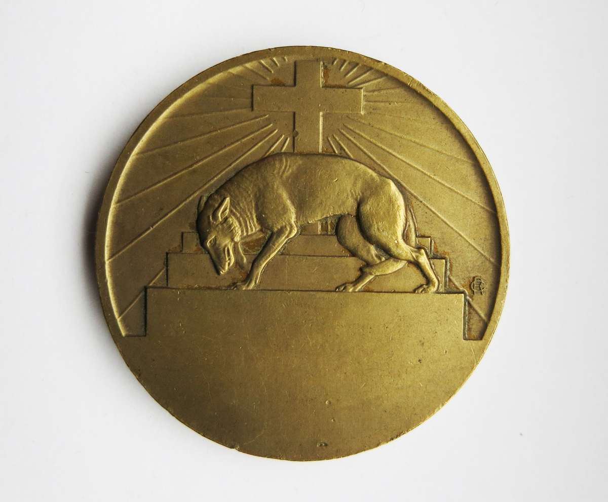 Motiv advers: Frans av Assisi preker for fuglene.

Motiv revers: På trappeformet pidestal et latinsk kors. Foran en ulv. Nedferst åpent rom for inngravering.
