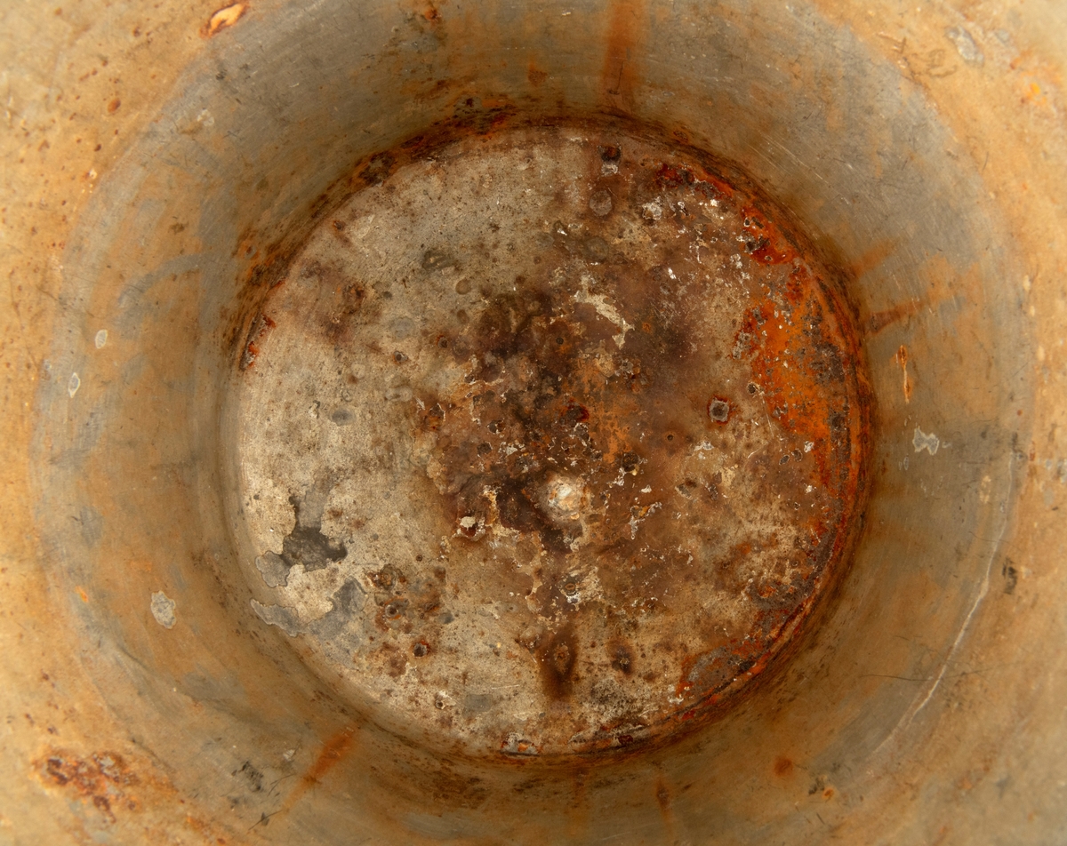 Bøtte av den typen det var vanlig å bære vann i. Bøtta er sveiset ihop av jernblikk. Den er rund, med en diameter som øker fra standflata (18,4 centimeter) til overkanten (27,1 centimeter). Høyden på sjølve beholderen er 23,4 centimeter, regnet fra underlaget til overkanten. I den nedre enden er det en forsterkende fals. Botnplata er noe nedoverbuket. Ved overkanten, diametralt plassert i forhold til hverandre, er det påsveiset «ører» med gjennombrutte hull for feste av bærehanken, som er buet i halvsirkelform. Den ene av disse er plassert over sveiseskjøten som binder plata i sideveggen sammen, og har dermed fungert som forsterkende element i tillegg til å være hankfeste. Hanken er lagd av 2,35 millimeter tjukt galvanisert jern. Den er 1,14 centimeter bred og har et U-formet tverrsnitt, der den runde sida er nedovervendt, slik at hanken ikke skulle gnage i fingrene på bæreren. Bøtta har noe rust i den innvendige botnen, men den er fortsatt tett. Den rommer drøyt 8 liter væske når den fylles breddfull.