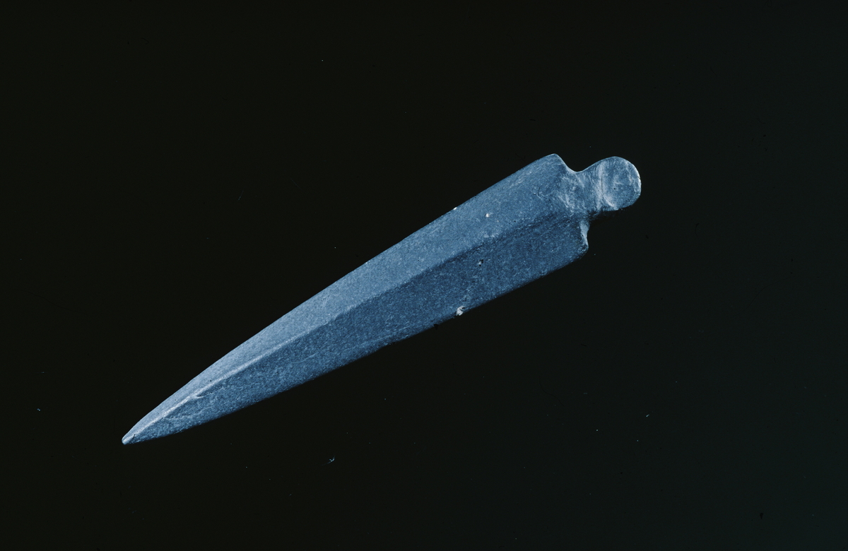 Skiferpil funnet ved Store Myrvatn i 1938. L. 7.2 cm, st.br. 1.2 cm.