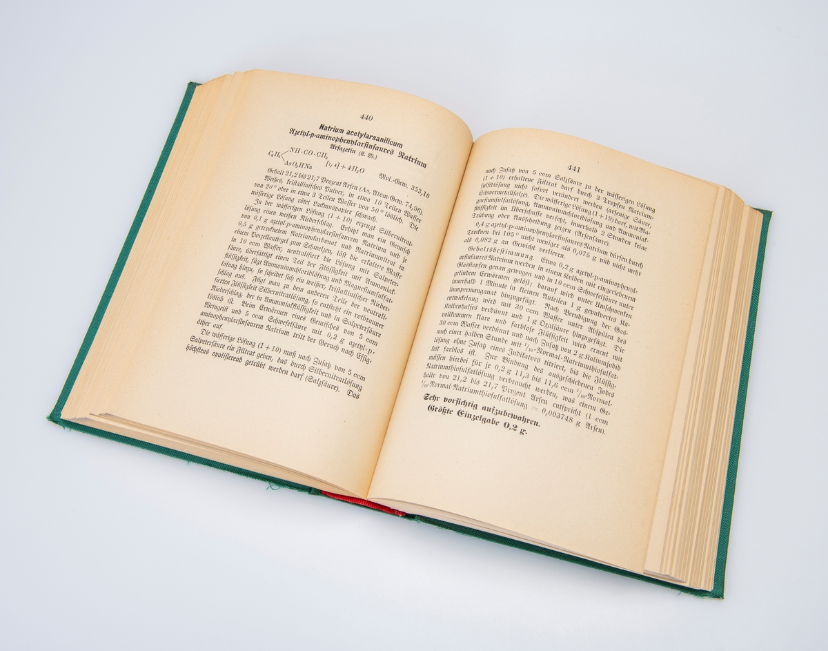 Innbundet tysk farmakopé fra 1940, med tilhørende løst vedlegg fra 1939. Begge er av den 6. utgaven av originalboken fra 1926. Boken er trykket med gotisk skrift typisk for tyske verker i denne perioden. Den tyske Reichsadler med hakekors opptar forsiden. De første to sidene i boken er stemplet av Løveapoteket. Vedlegget her på totalt 14 sider. Boken har en innledning på 55 sider i romertall, og 854 sider med innhold.