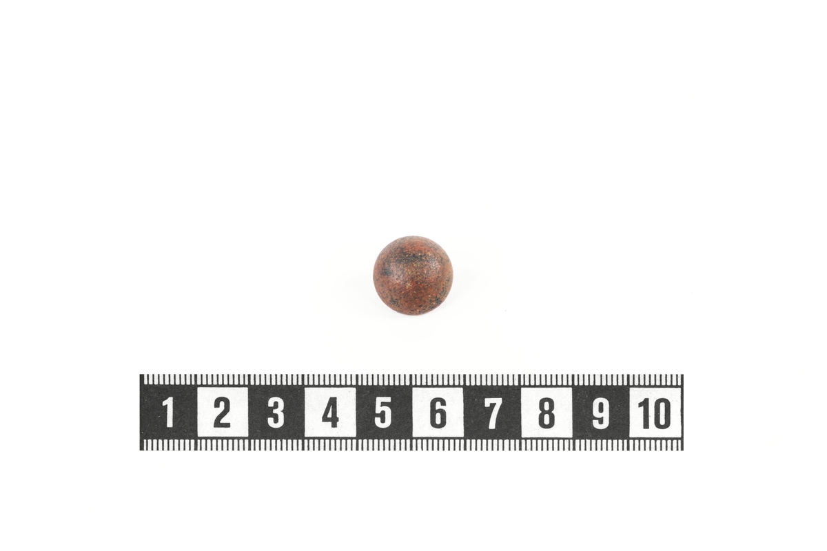 Rund knapp av koppar med en trådögla i botten.