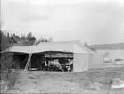 Sjöflygplan i tälthangar vid strand, 1910-talet.