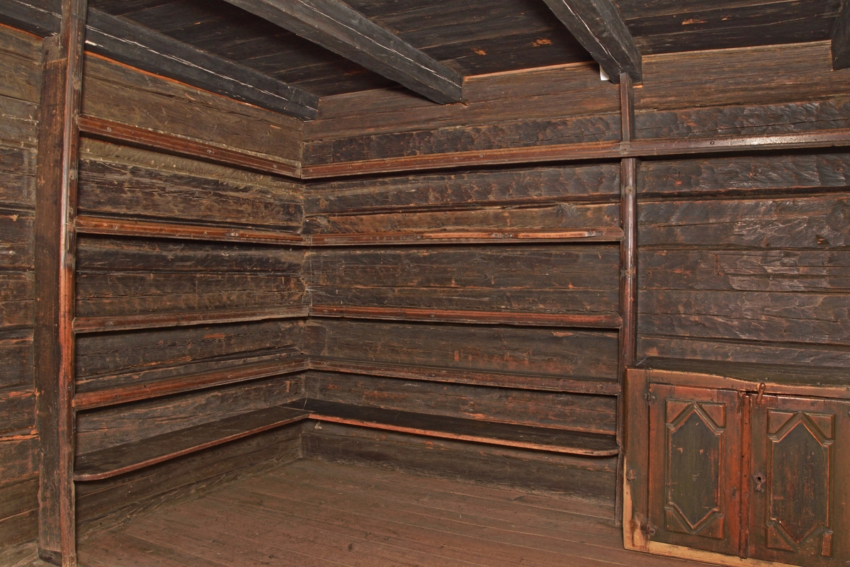 All shelves with moulded edges. Wider shelf below. The rack is attached to the wall.