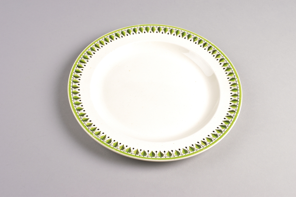 Stilisert borddekor i to grønnfarger langs kanten.