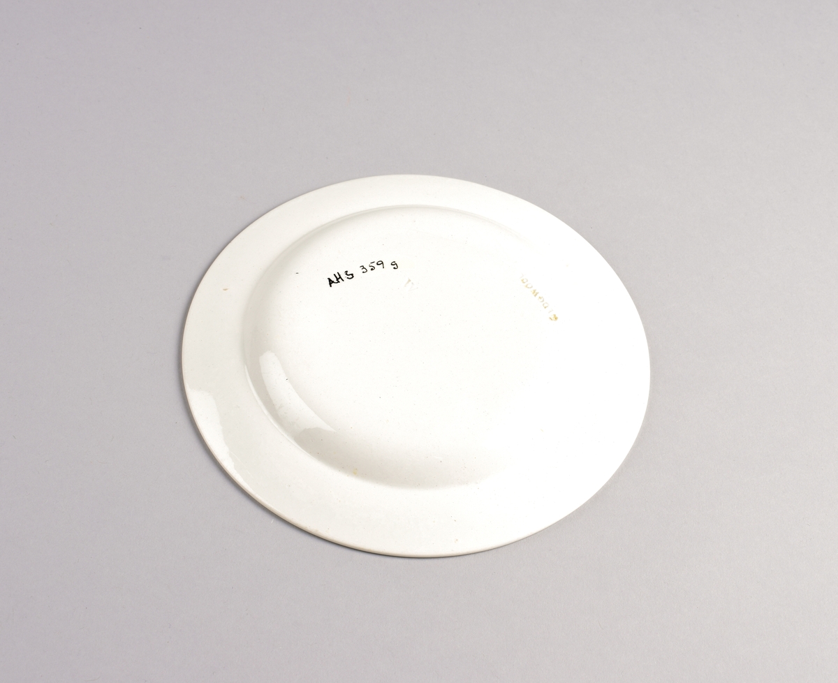 Stilisert borddekor i to grønnfarger langs kanten.