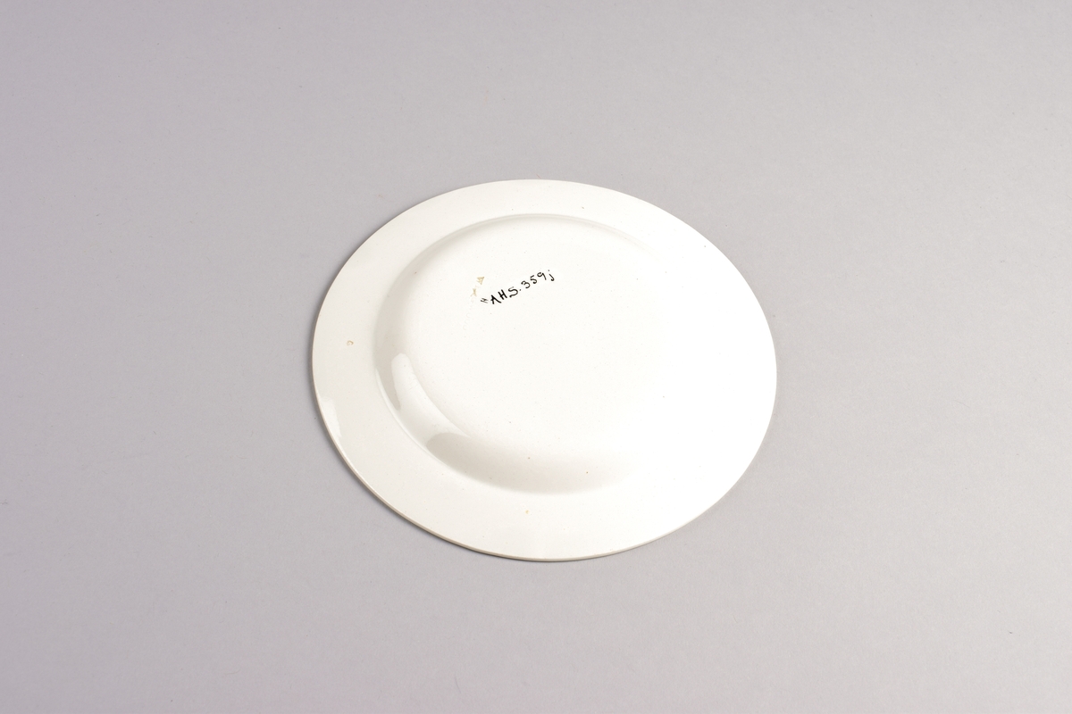 Stilisert borddekor i to grønnfarger langs kanten.