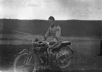 En militär sitter på en motorcykel, 1920-tal.