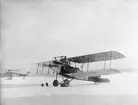 Flygplan Albatros NAB 9 nummer 854 samt flygplan FVM S 18 uppställda på flygfält, vintertid omkring 1919-1925.