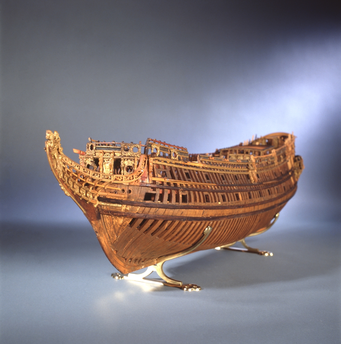 This unplanked model of a three-decker can be dated to c. 1660 and is one of the world's oldest models of a warship. Although not definitively identified, recent research links it to the Swedish ship *Riksäpplet*, designed by the English master shipwright Francis Sheldon and launched in 1661.     
The model was possibly made for Sheldon, who came to Sweden in 1659. He was one of a number of English shipwrights employed by the Swedish crown during the period. Previously, most Swedish warships had been built in the Dutch style.

From around 1660, the English Royal Navy’s administrators commissioned models that were accurately detailed and true to scale. These miniatures, which came to be called Navy or Admiralty Board models, had an unplanked lower hull to emphasise the shape of the underwater body. 

The model was restored by rear-admiral Jacob Hägg in the late 1890s. Missing parts have been reconstructed using lighter coloured wood.

3D model produced by Adam de Kaminski and Vasilis Haroupas for SMTM, 2023
