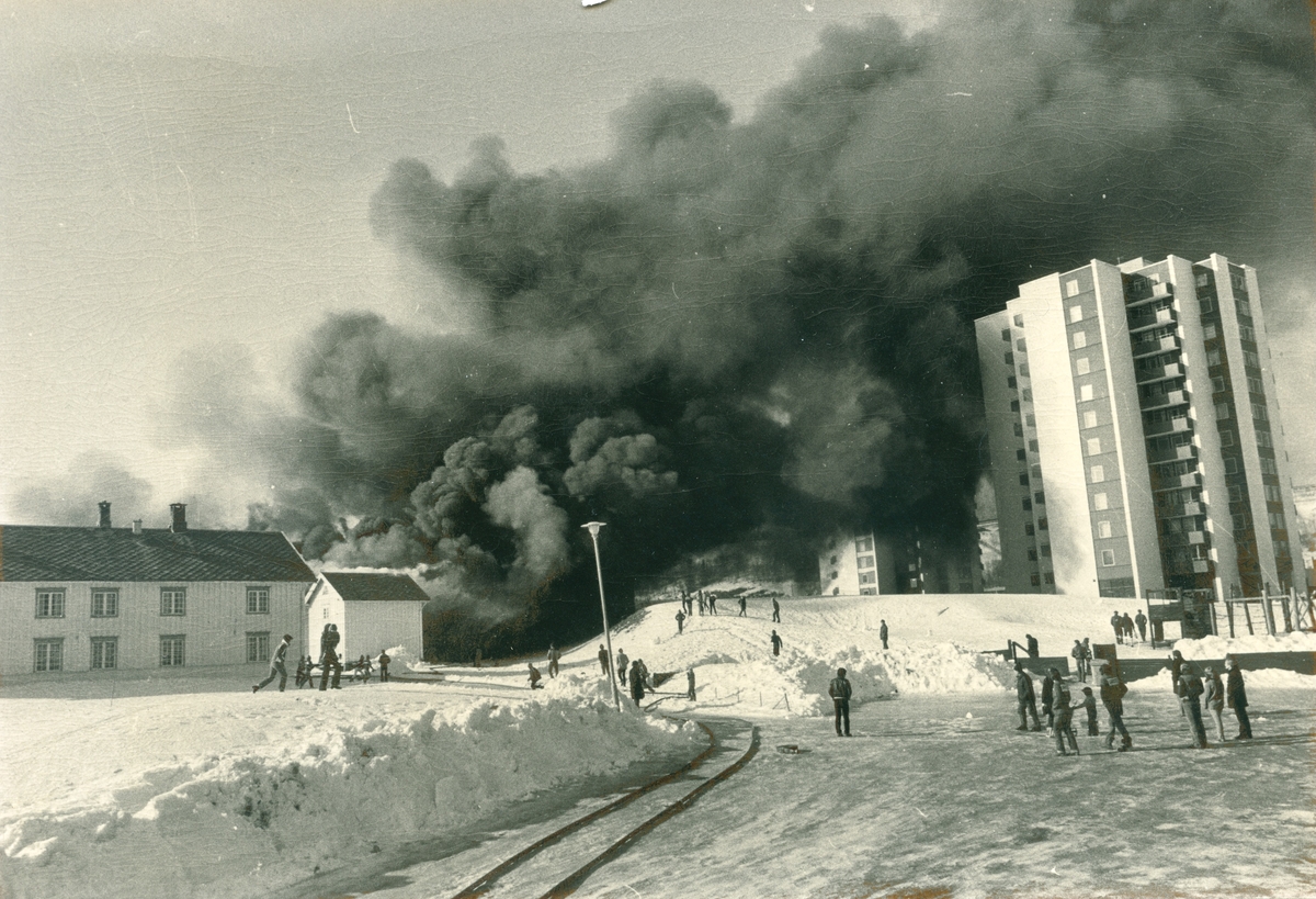 Tre bilder som viser en brann i noe som kan ligne en låve e.l. i nørheten av boligblokker. Bygningen er totalskadd. Snø. Røyk.