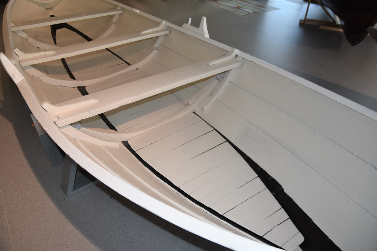 Færing av strandebarmar type. Fire omfar/bordgangar, tre spant, fram- og bakrong. Båten har berre eitt par keiper, med keipsneve og tollepinne. Haldar for reiskap festa til esing. Restar av metallband langs kjølen, der bandet går opp over framstavn og akterstavn og festa over toppen på stavnane.