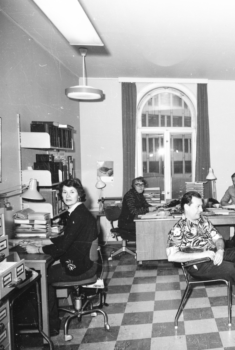 Kontorlandskap med ansatte i arbeid, både kvinner og menn.