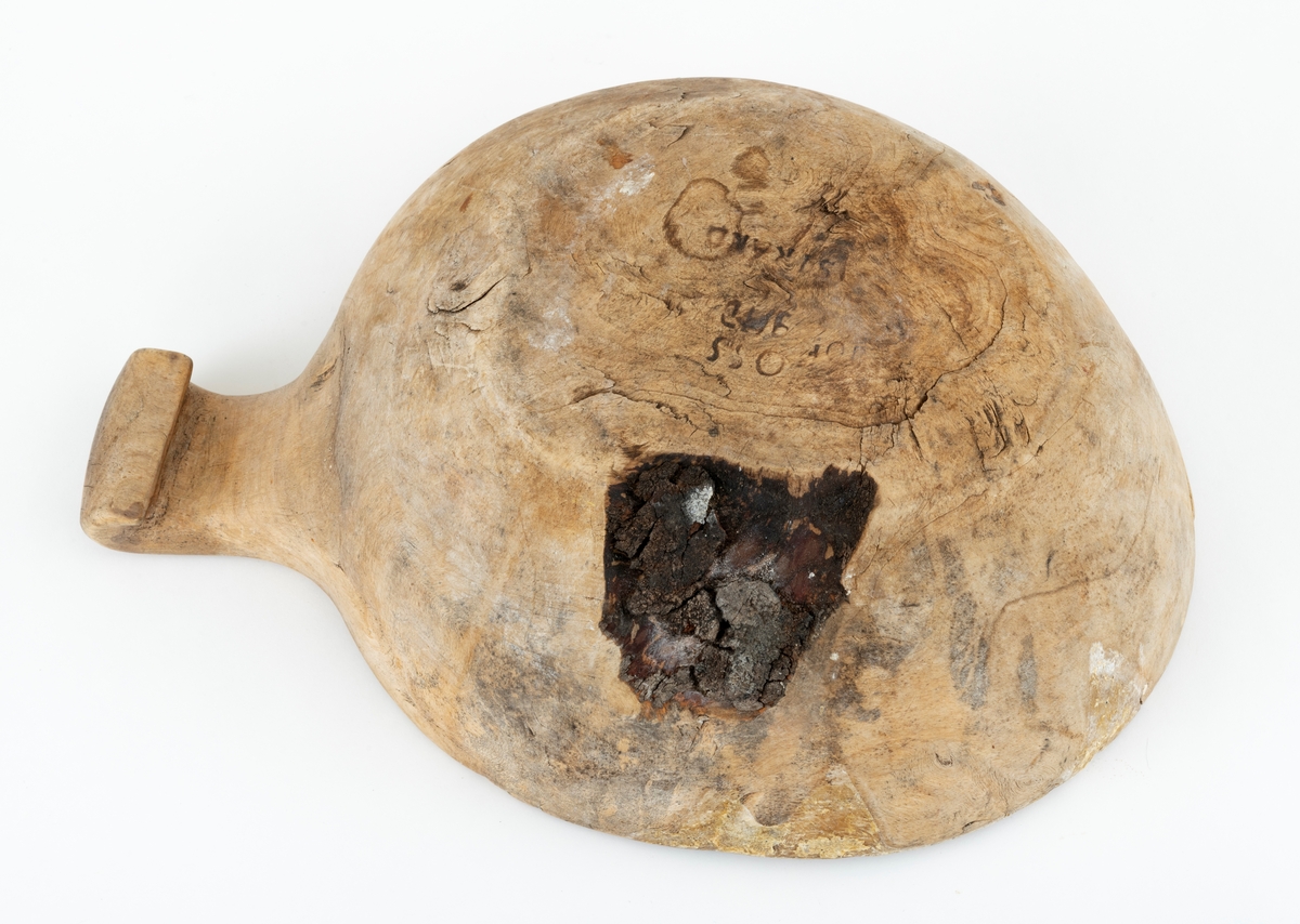Bolle, skåret ut av ei stor kåte eller rirkule, antakelig fra et bjørketre. Formen på bollen gjenspeiler den formen utveksten på treet må ha hatt - rund, men ikke helt sirkulær. Diameteren varireer mellom 26,5 og 30,3 centimeter. Dette er yttermål, tatt ved overkanten. Standflata er også rund og måler 16 X 18 centimeter. Høyden fra underlaget - vanligvis ei bordplate - er fra 9 til 10 centimeter, avhengig av hvor målet tas. I forlengelsen av bollens overkant er det et cirka 7,5 centimeter langt handtak. Dette handtaket er om lag 6,9 centimeter bredt i ytterenden, men sett ovenfra er det en aning konkavt. På undersida av handtakets ytterende er det en krok. Bollen har noen små sprekkdannelser langs overkanten. Innvendig er det et gråkvitt belegg. På standflata finner vi ulike svijernstempel - «OSS», «IHD» og «STRAND». De to første er utvilsomt initialer, og «IHD» refererer sannsynligvis til Ingeborg Helgesdatter (1880-1880), som i 1822 giftet seg med Peder Tollefsen (1896-1971) og dermed ble kjerring på gardsbruket Lillebekken på Tolga, der denne bollen kommer fra. Stempelet «OSS» refererer antakelig til et mannsnavn av typen Ole Simensen, men disse initialene lar seg ikke lett knytte til eiendommen Lillebekken. Ingeborg Helgesdatter svigerdatter kom fra et bruk ved navn Strand i nabobygda Os. Objekter som dette kan naturligvis både ha gått i arv og være kjøpt på auksjon.