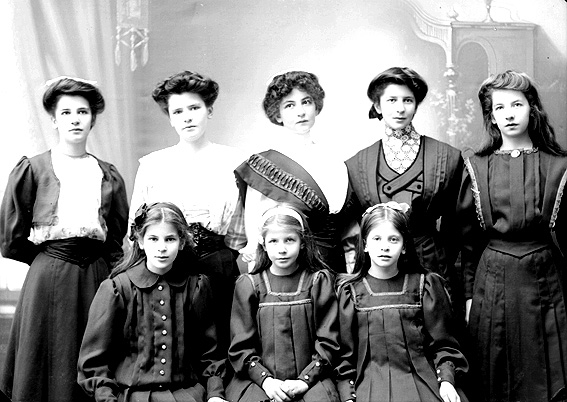 Anton Sundelius 8 döttrar framför Karl Nyströms kamera i ateljén i Klara. I främre raden: Aina, Elsa-Britta och Helmi och i övre raden: Ethel, Märta, Ebba, Vivi och Elly.  Bilden togs kanske i samband med faderns 50-årsdag år 1908