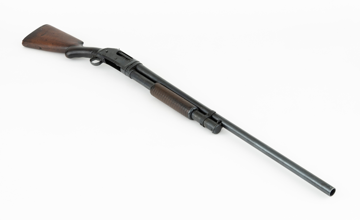 Winchester Model 1897, ei pumpehagle med rørmagasin, produsert av Winchester Repeating Arms Company i New Haven i Connecticut i USA (1866-2006). Dette våpenet er også kjent som Model 97, M97, eller Trench Gun. Model 1897 var en videreutvikling av Winchester Model 1893. Formgiveren bak disse våpnene var børsemakeren John Moses Browning (1855-1926). Magasinet sitter på undersida av løpets bakre del. Det er omgitt av et sylindrisk treskjefte. Når dette handtaket trekkes tilbake, trekkes også sluttstykkebolten bakover, slik at den tomme patronen kastes ut. Når det nevnte handtaket skyves framover igjen mates en ny patron inn i kammeret. Magasinene i Model 97 hadde vanligvis rom for 6 haglpatroner. Våpenet har full trangboring, det vil si at løpet, som bakfra har en diameter på 18,4 millimeter, men er cirka 1 millimeter trangere i den fremre enden. Dette ble gjort for å begrense spredningen haglene fikk på sin veg mot målet. Winchester Model 97 ble produsert i over én million eksemplarer i perioden 1897 til 1957. Ei innstemplet liste over patenter som ligger bak dette våpenet tyder på at den avbildete modellen er produsert etter 1906. Model 97 regnes som den første vellykte pumpehaglemodellen som kom på markedet. Den ble brukt av amerikanske soldater og politiavdelinger, samt av jegere. Her til lands har slike geværer vært omtalt som «Western-våpen». Den avbildete hagla er velbrukt, antakelig av en norsk jeger. Kolben, som ser ut til å være lagd av nøttetre, har tre innskårne bokstaver - «LBR» - som kan ha vært initialene til tidligere eier. 

Denne Winchester-hagla har vært innlånt til museet, men ble fotografert før den ble returnert til eieren.