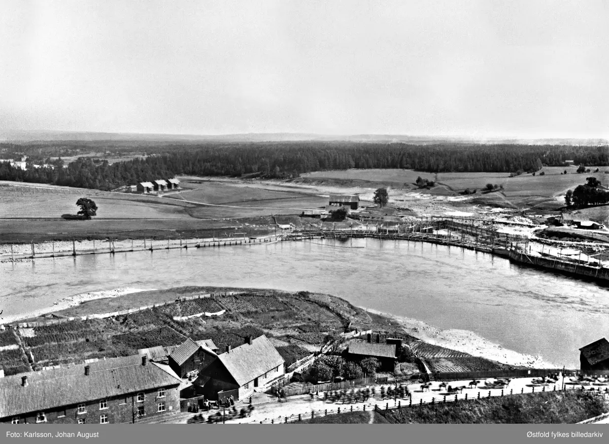 Tarris arbeiderbolig i østre del av Sarpsborg med omgivelser, i  bakgrunnen Grøtet-brua, 1899. I forgrunnen soldater på utmarsj under den store feltmanøveren i 1899.