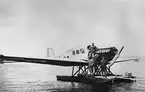 Ambulansflygplan Trp 1, Junkers F 13, på flottörer, omkring 1930. Fyra män vid flygplanet.