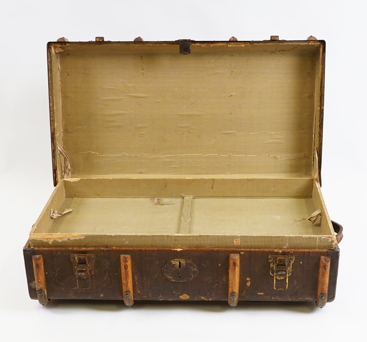 Koffert av tre kledd med strie på utsida og papir på innsida. På utsida er det beslag av tre forsterka med metall. Innvendig er kofferten delt med ei skuff til å løfte opp.