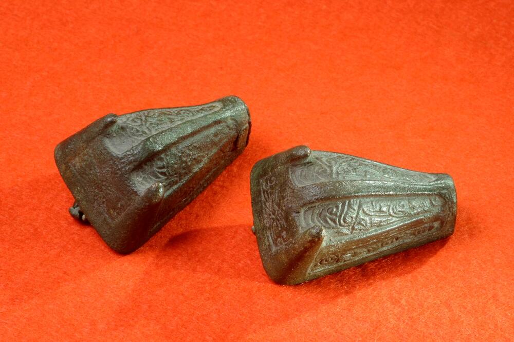 Två st djurhuvudformiga spännen från grav 224, i övrigt se hnr gfc9322_1 och _199 undersökningen på gravfältet vid ire i hellvi år 1942 omfattade totalt 61 gravar, av dessa har fynden från 47 stycken tilldelats gotlands fornsal och finns i ark mag, av de övriga var 8 stycken helt utan fynd, möjligen med fragment av brända ben. Fynden från de resterande 6 gravarna finns på historiska museet i stockholm, rapport över samtliga undersökta gravar finns i gotlands fornsals arkiv med kopior i ark mag. Gravnummren som används baseras på den inventering av gravfältet som e floderus och n gillgren gjorde år 1933 - 34. Eventuella undernummer eller bokstäver tillfogade till gravnumren  kom till i samband med undersökningarna då en del gravar som vid inventeringen bedömts vara en grav ibland var två eller till och med tre rösen tätt tillsammans
2 st. Djurhuvudformiga spännen, med nål av brons, nedsliten och vittrad, upplöst djurornamentik. L. 5,4 cm. Från grav 224.