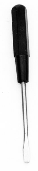 a) Symaskin av märket Husqvarna, modell V.S.4. Handdriven. Svartmålad på träplatta. Nersänkt låda med tillbehör. b) Huv av ekfaner. Handtag på toppen. c) Skyttel av stål. Rund, spetsig i ena änden, rak i den andra. Innehåller en spole med vit tråd. d) Fem spolar av stål. Rund stav med plattor i ändarna. Olika trådrester. e) Ledpressarfot (monterad på maskinen). f) Fållvikare 2 mm. g) Fållvikare 6 mm. h) Gansapparat. i) Rynkfot .j) Linjal. Längd 5,3 cm. k) Fem symaskinsnålar i olika grovlekar. Cellofanförpackning. l) Skruvnyckel. Typ lång platt nål, bakre delen försedd med runt hål. m) Skruvmejsel av stål. Fäste av svart bakelit. n) Borste av dubbelvriden ståltråd med en borste i ena änden. o) Skruvmejsel av stål. Fäste av svart bakelit. p) Provlapp av bomullsflanell. För kontroll av stygnställning. q) Provlapp av bomyllskypert. Till kontroll av stygnställning. r) Bruksanvisning. Tryckt broschyr på 30 sidor.