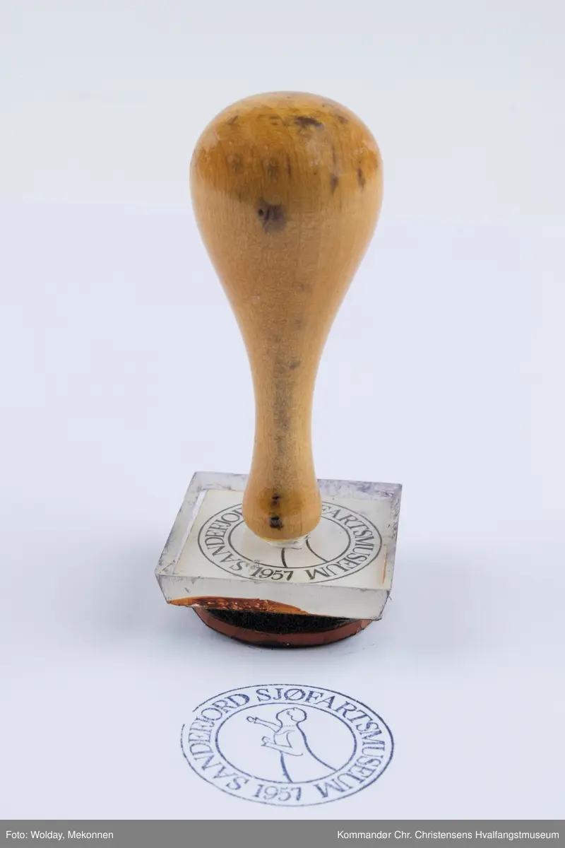 Stempel med trehåndtak med teksten SANDEFJORD SJØFARTSMUSEUM 1957