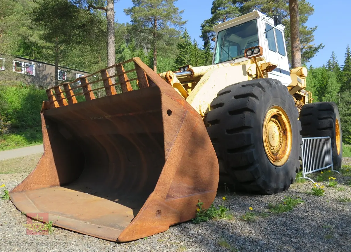 International H-400C Payloader. Hjullaster på 4 hjul, antatt 4-hjuls drift. Gul og svart. Motoren er en turboladet V12 Cummins type VT1710C-635. Dette er en 4-takts diesel med et cylindervolum på 1710 cu. in. (28 liter), Effekt 473.5 kw (635 hp). Skuffa rommer ni kubikkmeter.
Girkasse fra International Harvester, modellbetegnelse P-600S (to-trinns). Merking fra produsent og første bruker.