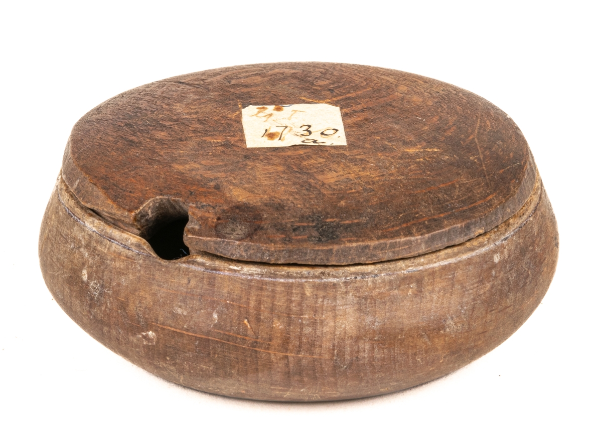 Rakdon av trä, rund liten ask med lock. Tillhör också en  borste med bågformigt skaft av trä.