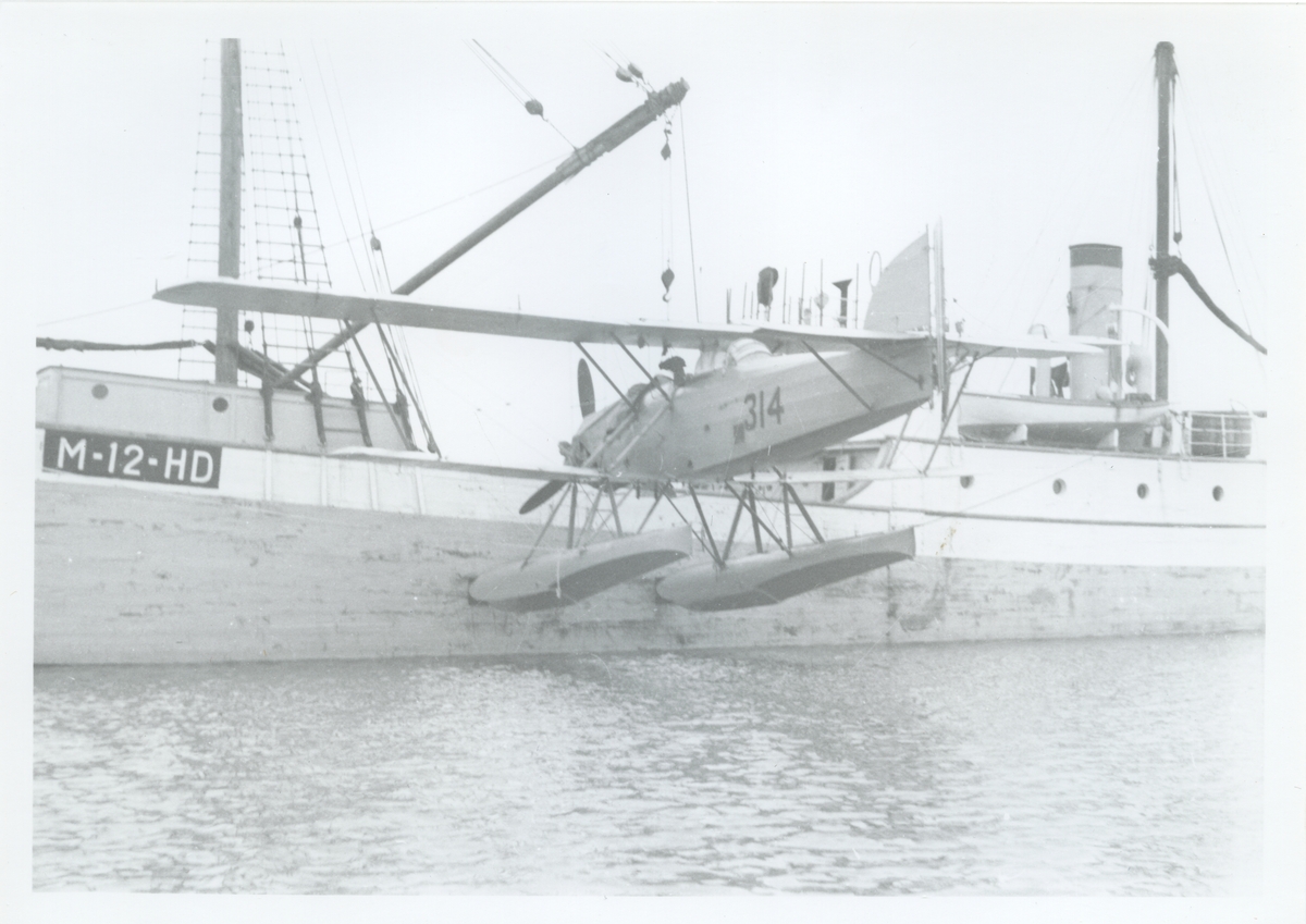 Fly 314 blir satt på vannet fra ishavsskuta Polarbjørn .Den første kartleggingsekspedisjonen av Svalbard med fly sommeren 1936. Luftfotograferingen ble utført for Norges Svalbard- og Ishavs-undersøkelsers (NISU) kartleggingsekspedisjon. Kartleggingen ble utført med et av Den norske marines fly og piloter var kommandør Gösta Wendelbo og løyntnant Sigurd Sivertsen mens Bernhard Luncke var flyfotograf. Sistnevnte var også leder for ekspedisjonen. De hadde hoverbase på Kapp Smith.hvor det ble reist to små hytter. (kjøkkenbygning og radiostasjon med mørkerom.) De reiste også der en minnestein med navn alle 7 ekspedisjonsdeltagere.Flyet: Det er MF 11 (Marinens Flyvebaat)  var et norskprodusert sjøfly konstruert av kaptein Johan E. Høver sammen med kaptein Trygve Sundt ved Marinens Flyvebaatfabrikk i Horten. Flyets registrerings nr :  F.314  - som var spesialtilpasset luftkartleggingen bl.a. med svingbart kamera. Båten er:   Ishavsskuta ”POLARBJØRN ” Nr 1      fiskerimerke:   M-12-HD I 1936 var skuta på kartlegging og opplodding  ved  Svalbard. Originalen funnet i en kjeller i Kirkenes etter krigen.