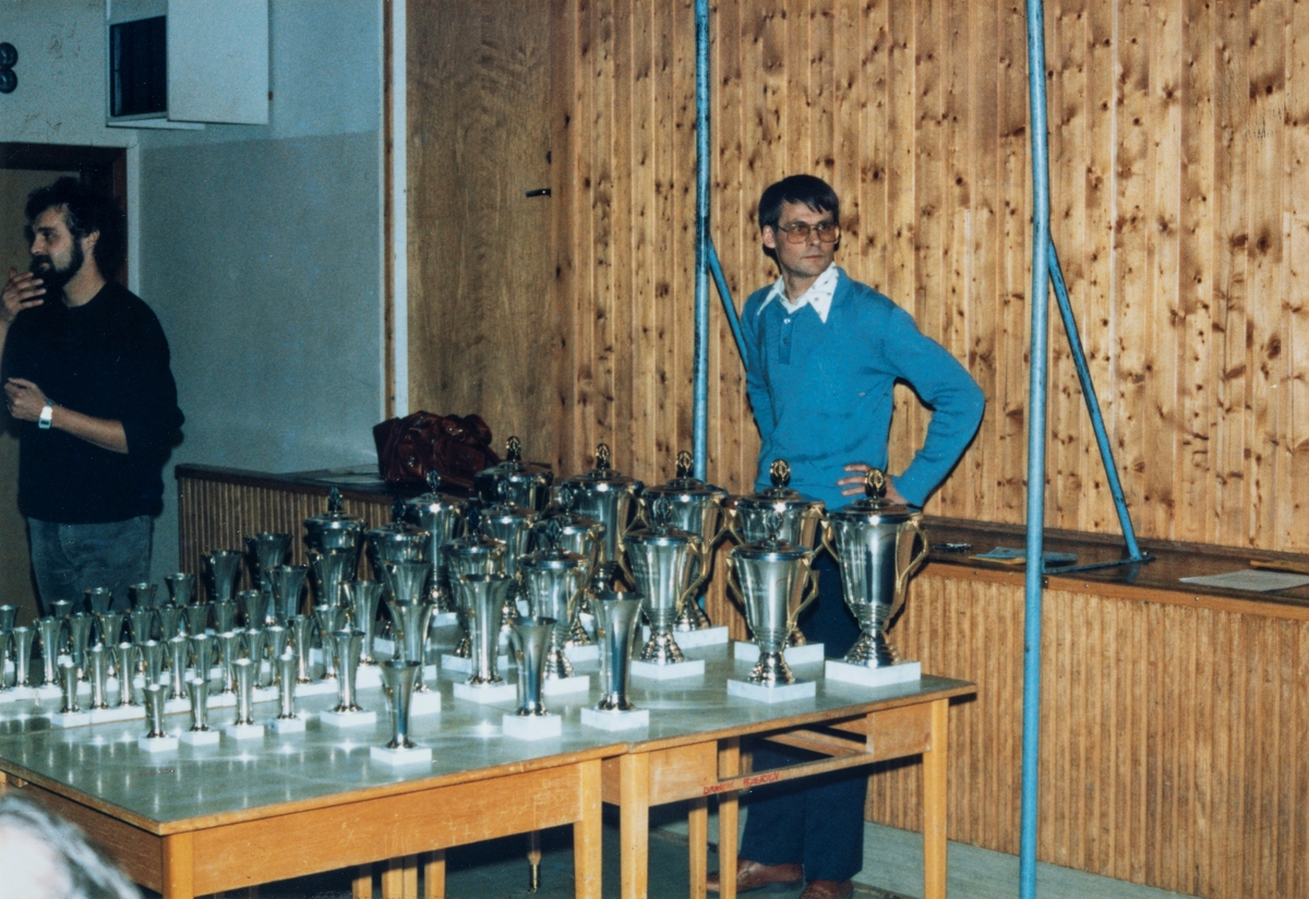 Jens Øvergaard stående ved premiebordet til NM i sjakk for ungdom i 1985. Sjakk NM ble arrangert av Løten Sjakklubb.