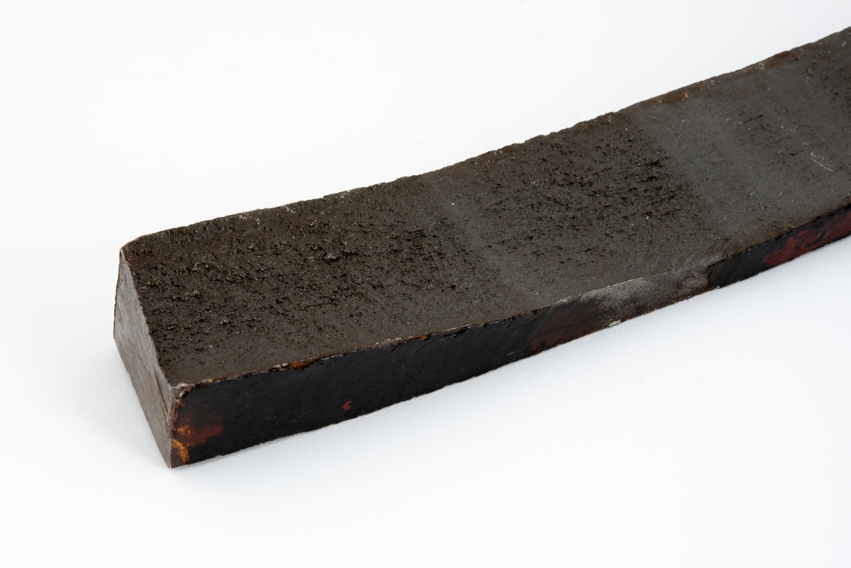 Metallprøve skåret ut fra bruddflate til stagdel fra D6 staget på riggen Alexander L. Kielland. 

Prøven viser regelmessige linjer "rastlinjer" i bruddflaten, og viser at sprekkens gradvise utvikling har medført at det har dannet seg et mønster i bruddflaten som kan sammenlignes med årringer i et tre. Slike linjer er typisk ved utmattingsbrudd og viser at metallet har gitt etter over tid. 

Den siden av prøvestykket som tilsvarer stagveggens utside er fremdeles dekket med maling.

Metallstykket har påført merking i gult og blått, og bokstaver og tall er risset inn i materialet. Det er sannsynlig at noe av denne informasjonen henviser til stagdel og avstand i centimeter fra initieringspunkt A for utmattingsbrudd. 

I noen tilfeller omtales initieringspunkt A som initieringspunkt I.