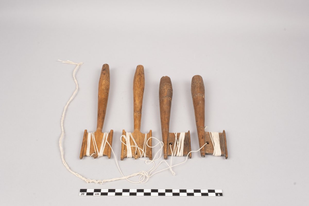 Ett sett slingrestrokker, 4 styker av to varianter, alle er av tre. To av stokkene er med dekorert håndtak og enkeltside hode for anleggelse av tråd. Hullet er plassert inn mot stokken omtrent midt på hodets lengde. Håndtaket er har et tilnærmet ovalt tverrsnitt som smalner ut mot hodet og mot den butte nedre enden. Håndtaket er dekorert med omgivende geometrisk dekor utgjort av trekanter som er skåret ut av treverket, samt tre linjer nederst på håndtaket. De to siste stokkene er med dobbelt hode for anleggelse av tråd på begge sider av stokken. Hullet er plassert mot enden, midt mellom utsvingingen av hodene. Håndtakene er uten dekor og har et tilnærmet ovalt tverrsnitt som smalner ut mot hodet og mot den butte nedre enden. De fire stokkene henger sammen via et påbegynt slingring stykke med bomullstråd.