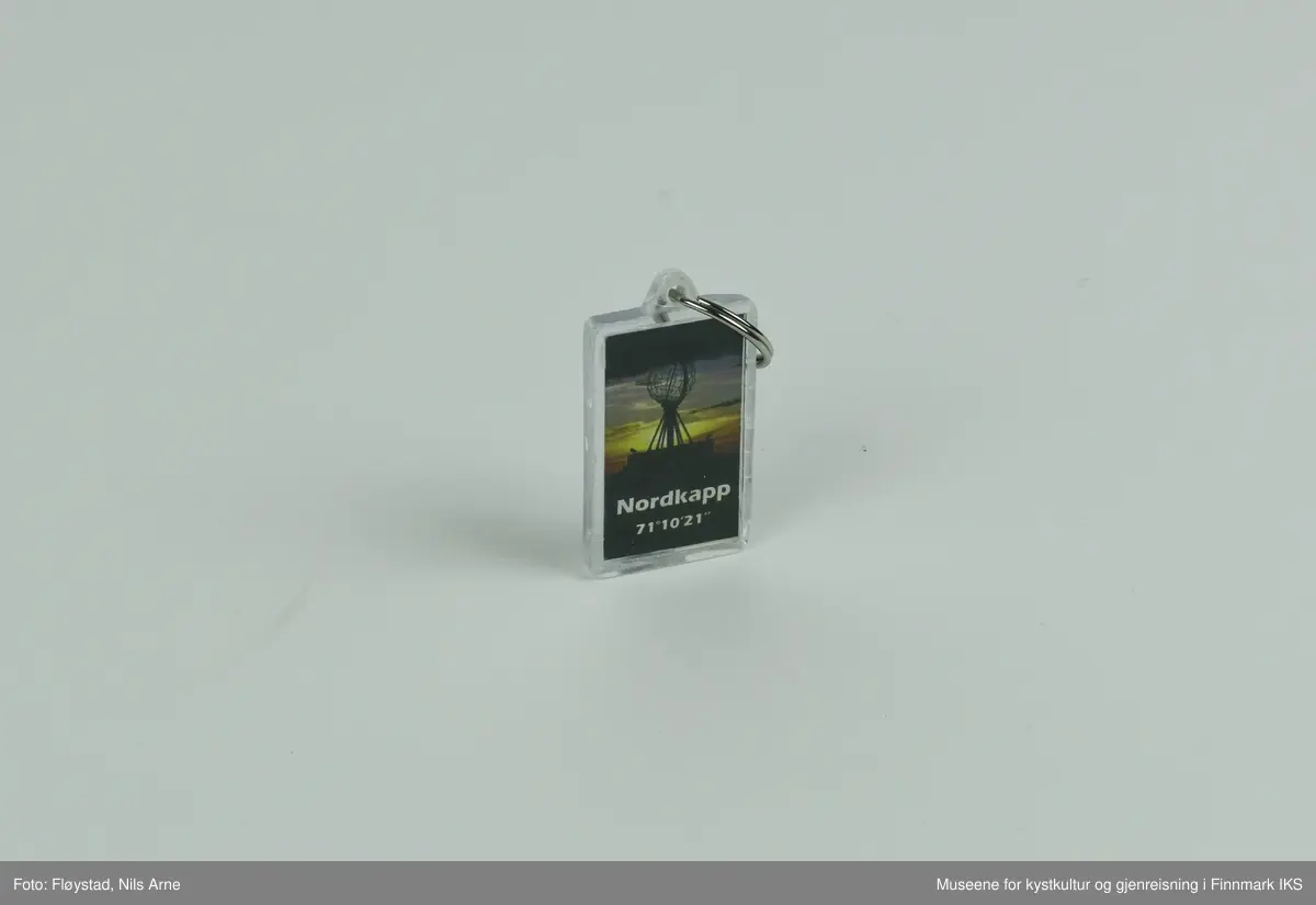 En nøkkelring festet i en rektangulær brikke med dekor og en gradestokk. 

Brikken er laget av pleksiglass eller akrylglass (PMMA), dekorert med et trykt fotomotiv på framsiden. Fotomotivet er av Nordkapp-globusen og en lettskyet, solrik himmel i bakgrunnen. Under motivet av globusen er det trykt "NORDKAPP 71°10'21" i hvitt.  Det er satt inn en liten gradestokk på baksiden av brikken som viser temperaturen i både Celsius ig Fahrenheit. Ved siden av gradestokken er "NORWAY" trykt i hvitt på en mørkeblå bakgrunn.