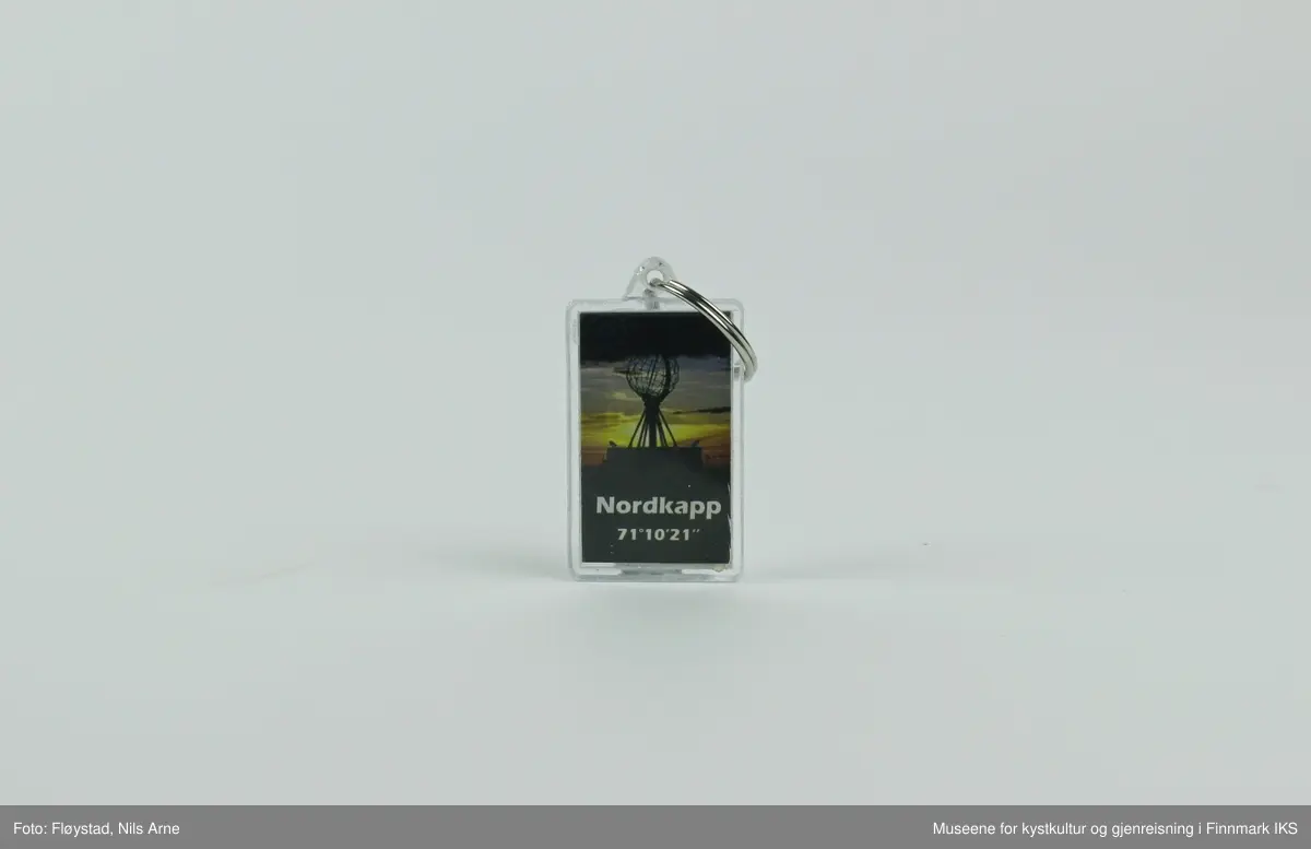 En nøkkelring festet i en rektangulær brikke med dekor og en gradestokk. 

Brikken er laget av pleksiglass eller akrylglass (PMMA), dekorert med et trykt fotomotiv på framsiden. Fotomotivet er av Nordkapp-globusen og en lettskyet, solrik himmel i bakgrunnen. Under motivet av globusen er det trykt "NORDKAPP 71°10'21" i hvitt.  Det er satt inn en liten gradestokk på baksiden av brikken som viser temperaturen i både Celsius ig Fahrenheit. Ved siden av gradestokken er "NORWAY" trykt i hvitt på en mørkeblå bakgrunn.