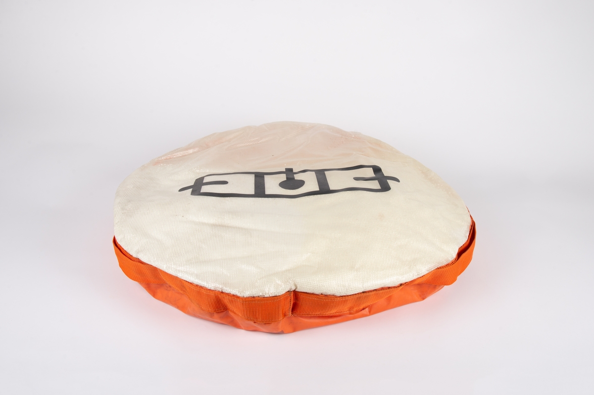 Sirkulær pute fylt med isoporkuler. Oransje underside og hvit overside.  Sort logo for Momentum Design på overside.