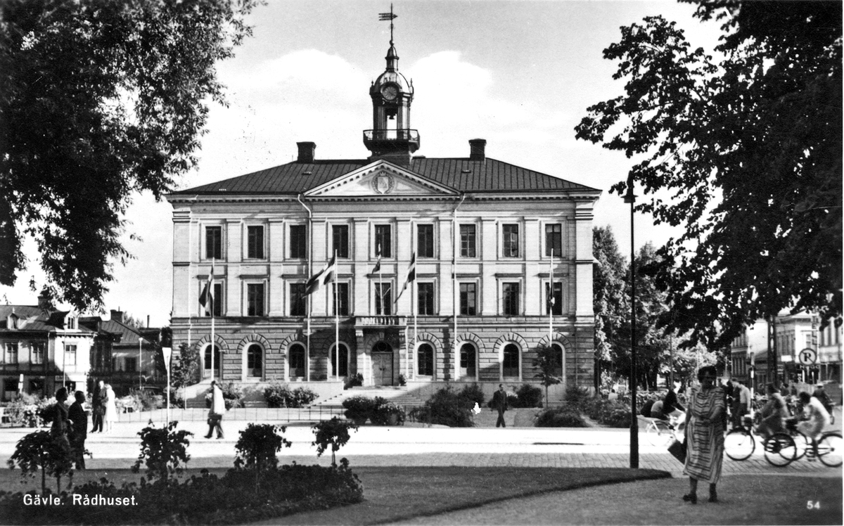 Gävle. Rådhuset. Byggnaden uppfördes 1784-1790 på kung Gustav III:s uppdrag efter ritningar av arkitekt Carl Fredrik Adelcrantz och landshövding F. A. U. Cronstedt i en franskinspirerad stil med drag av både rokoko och klassicism. Kungen lämnade ett bidrag om 4 500 riksdaler och donerade en porträttmedaljong i marmor utförd av Johan Tobias Sergel. Det äldre rådhuset från 1628, placerat något norr om det nuvarande, hade förstörts i stadsbranden 1776. Vid 1869 års stadsbrand skadades rådhuset svårt och återuppbyggdes 1871-1872 under ledning av arkitekt Gustaf Dahl. Exteriören förändrades då genom att fönstren på tredje våningen gjordes större och Adelcrantz släta fasad ornamenterades med bland annat lister. Sockelvåningen är dock lik den ursprungliga.