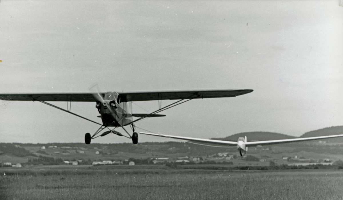 Et seilfly i slep etter Trondheim Flyklubbs Piper Cub (LN-RAK). Det tok rundt 8 minutter fra slepeflyet tok av til det landet igjen. Selve slepet ble vanligvis sluppet i 300 meters høyde.