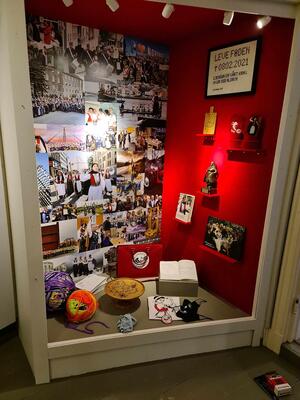 Foto av en monter i utstillingen I all offentlighet. I monteren ser vi fotografier og gjenstander knyttet til Bunadsgeriljaen.