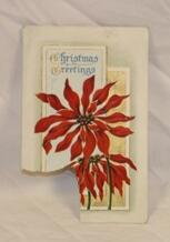 Postkort. Julemotiv. Julestjerne, tekst forgylt, kantet bakgrunn. Hjørne revet av (frimerke). Skrift, trykk og stempel på baksiden.