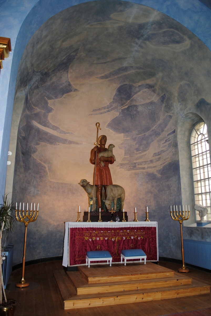 Interiör i Silbodals kyrka i Årjäng. Altarskulpturen och korfönstrets träreliefer är gjorda av konstnären Gunnar Torhamn.
