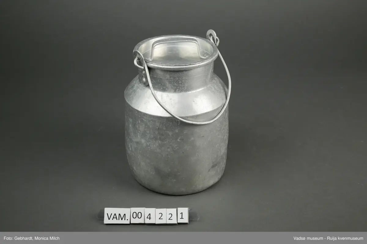 Sylinderformet aluminumsbeholder til oppbevaring og transport av melk. Spannet har hals, hengslet hank og lokk med håndtak. Kapasiteten til melkespannet er på 2 liter.