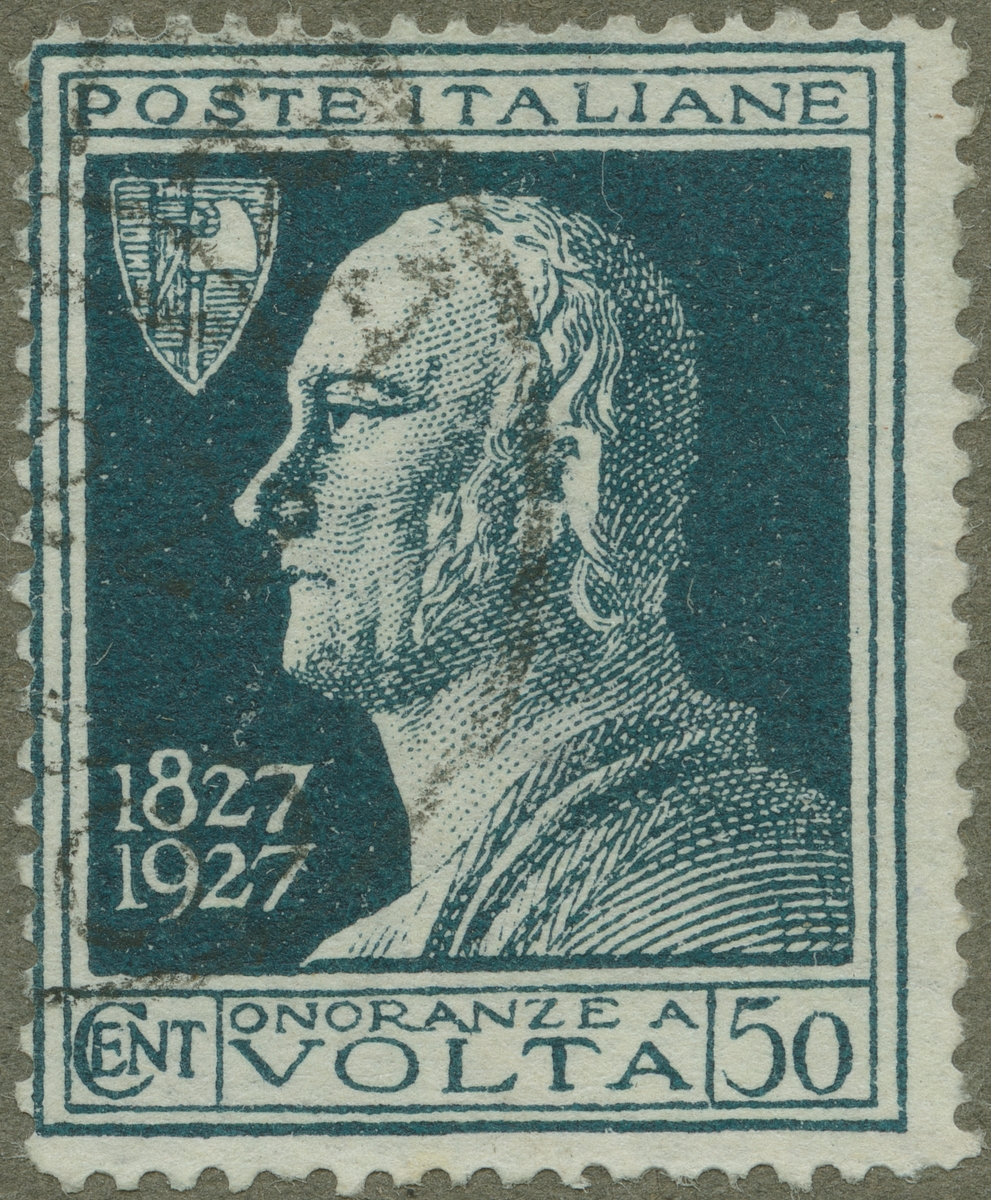 Frimärke ur Gösta Bodmans filatelistiska motivsamling, påbörjad 1950.
Frimärke från Italien, 1927. Motiv av Alessandro Volta 1745-1827. Italiensk fysiker. Spec. elektricitet. Elektroforen. Elektroskopet 1777. Elektriska kondensatorn 1782. Voltas stapel 1799. Enheten för elektrisk spänning- volt- är uppkallad efter honom. 100-årsminnet av hans död. 1827-1927.